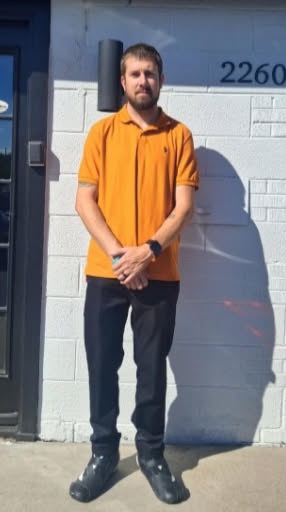 Cody Farrow standing in front of the church building